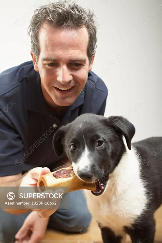Man Giving Dog a Treat   
