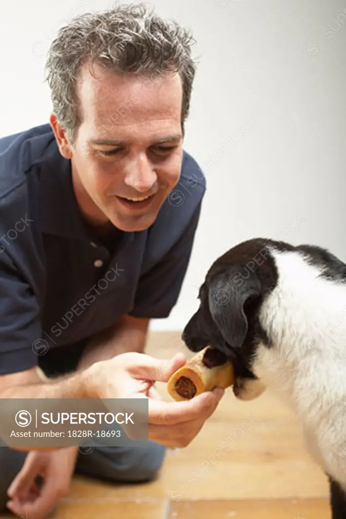 Man Giving Dog a Treat   