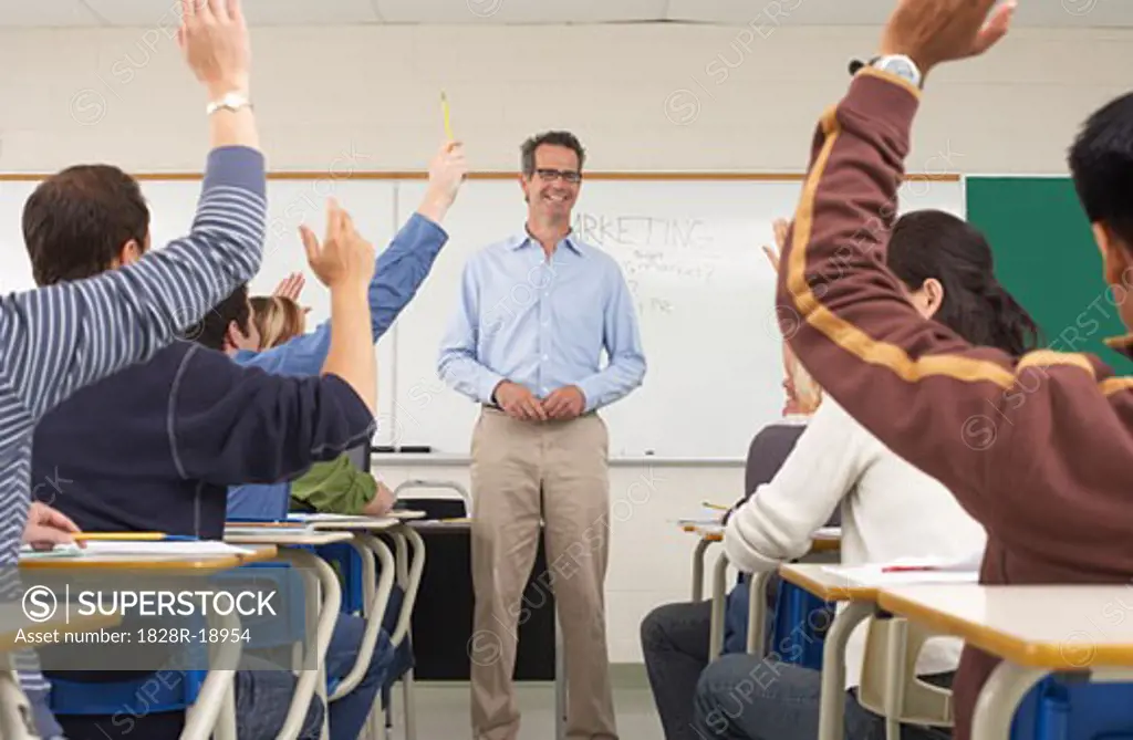 Students Raising Hands in Classroom   