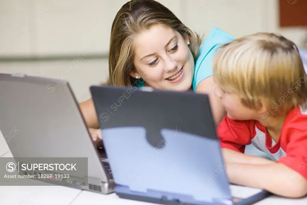 Girl and Boy Using Laptop Computers   
