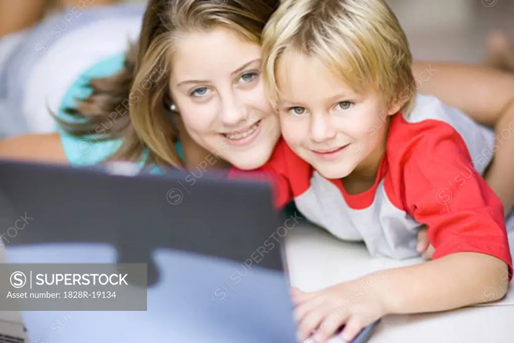Girl and Boy Using Laptop Computer   