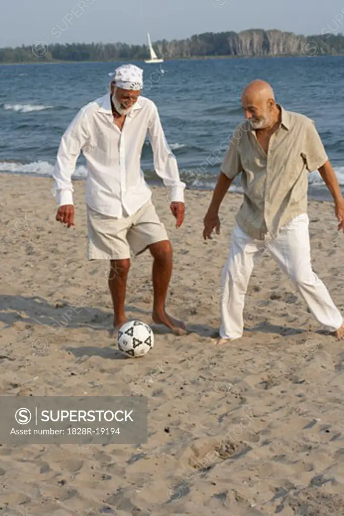 Men Playing Soccer on Beach   