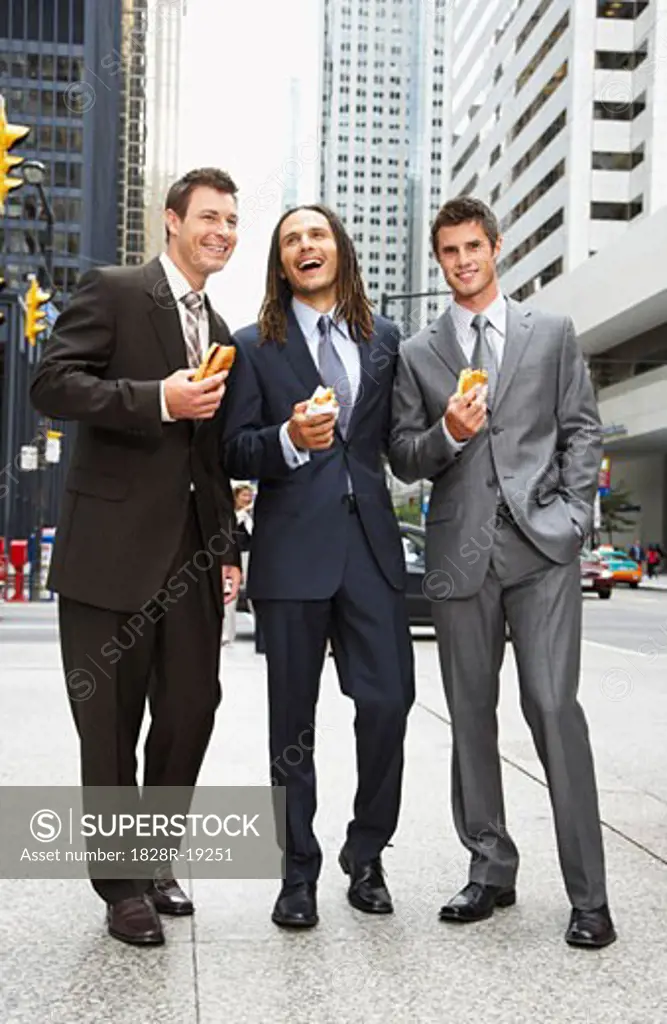 Businessmen Eating Hot Dogs   