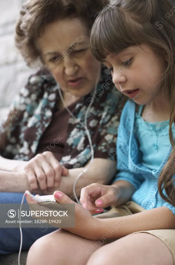 Grandmother and Granddaughter With MP3 Player   