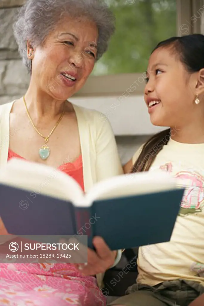 Grandmother and Granddaughter Reading Book   