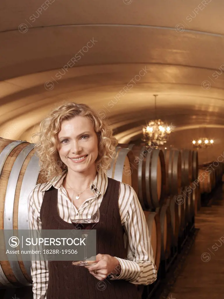 Woman Standing in Wine Cellar   