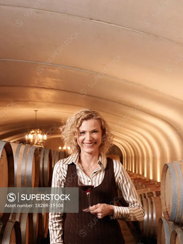 Woman Standing in Wine Cellar   