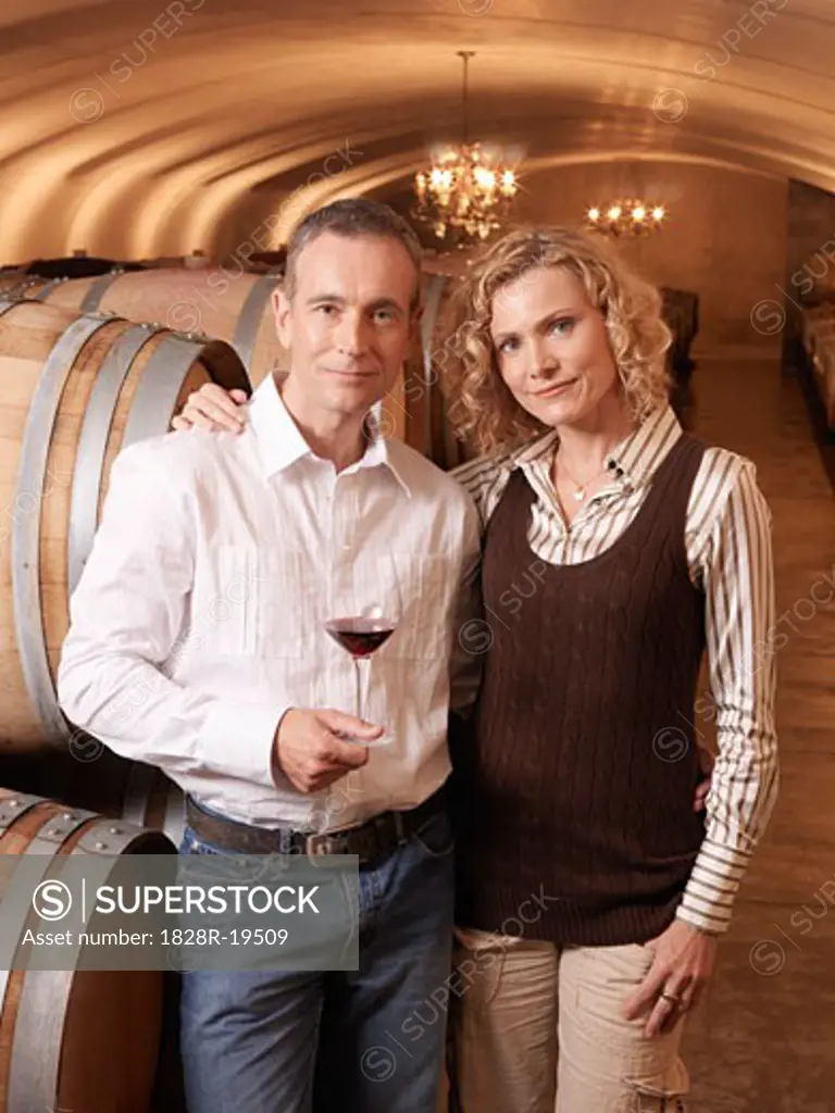 Couple Standing in Wine Cellar   