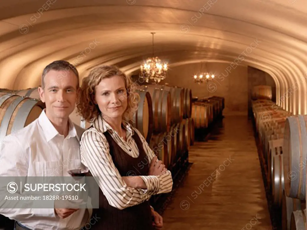 Couple Standing in Wine Cellar   