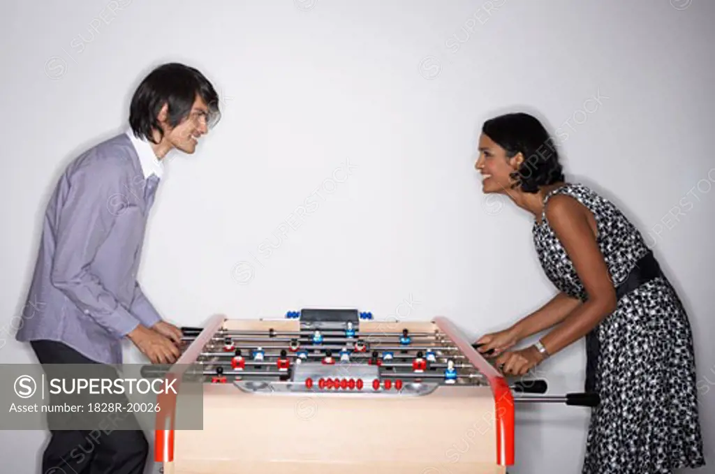 Man and Woman Playing Table Soccer   