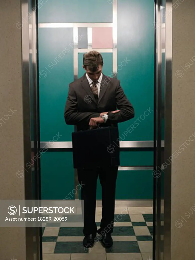 Businessman in Elevator   