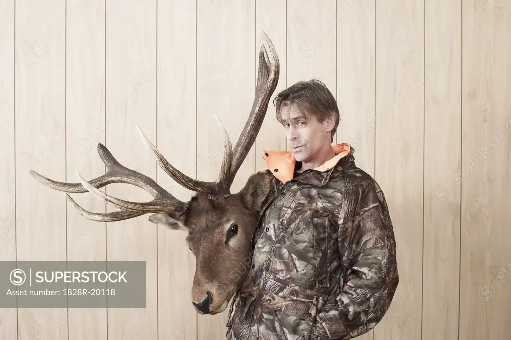 Portrait of Hunter Holding Deer Head   