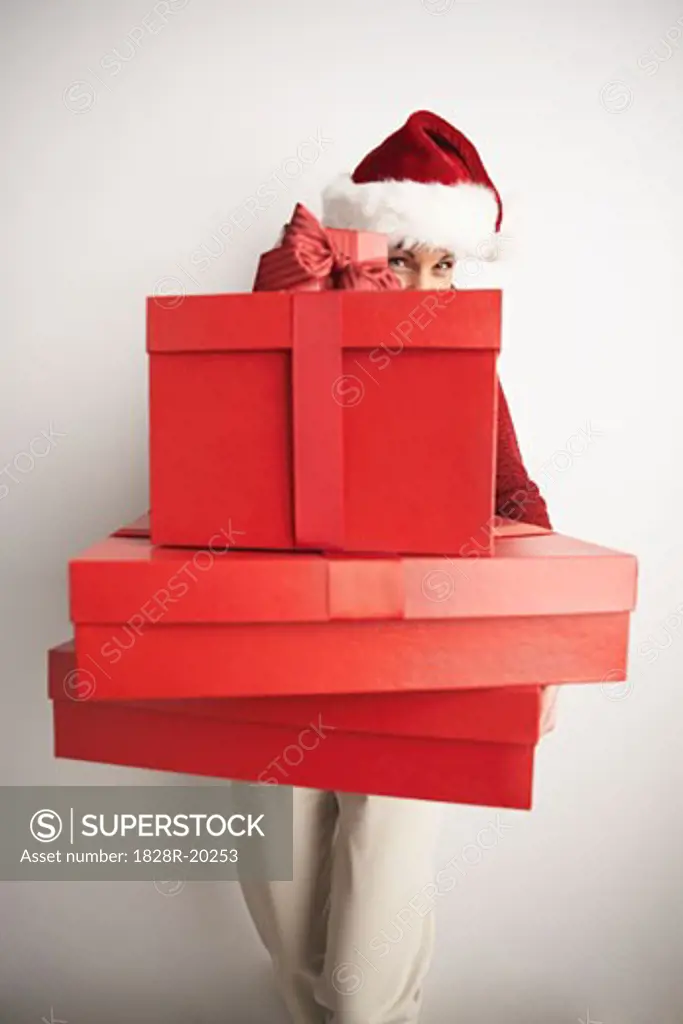 Woman in Santa Hat Carrying Gifts   