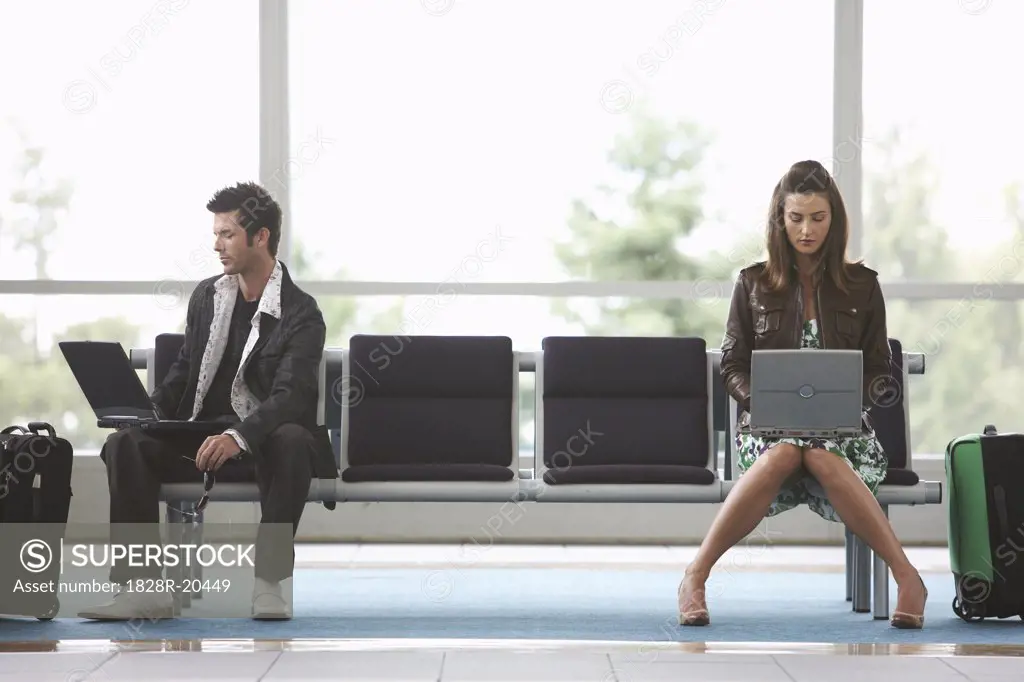 Man and Woman in Airport Waiting Area   