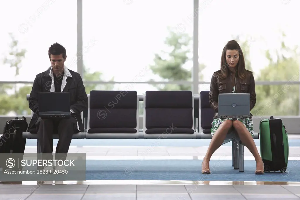 Man and Woman in Airport Waiting Area   