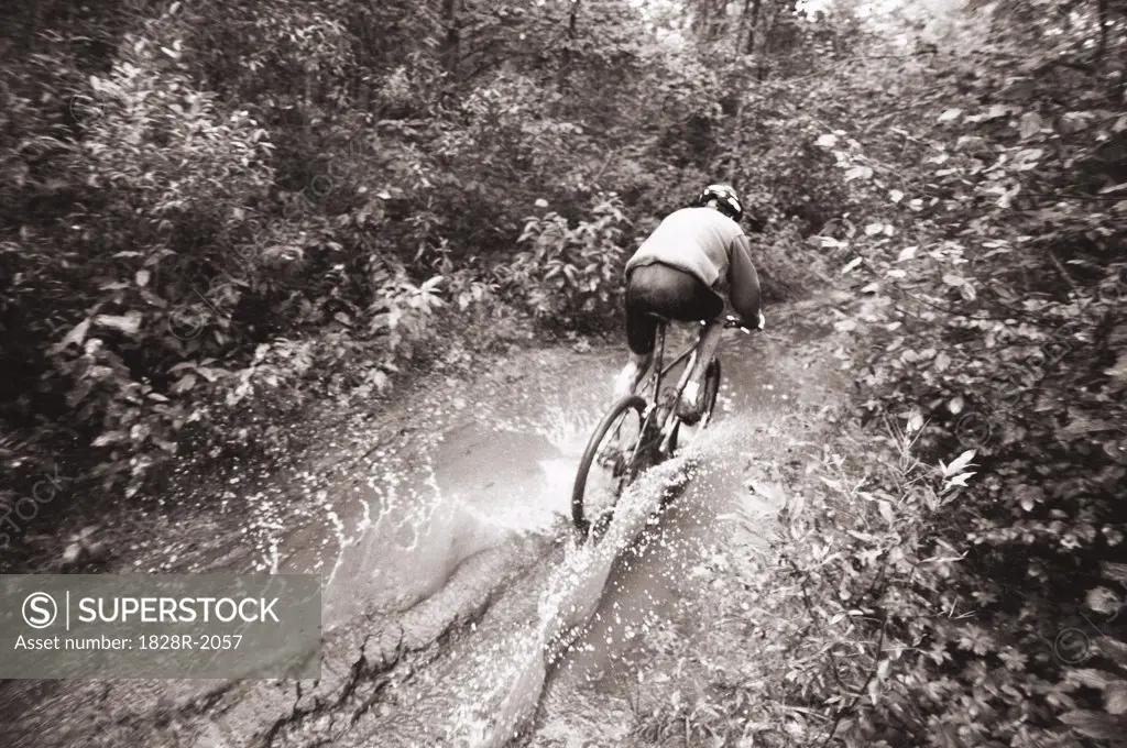 Mountain Biker Riding through Puddle Ontario, Canada   