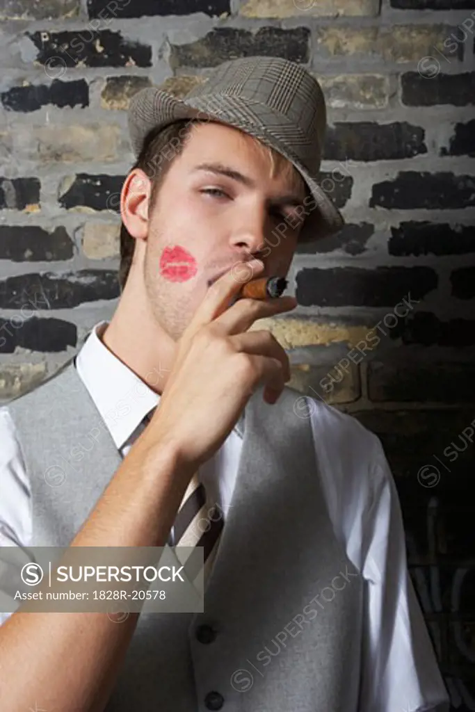 Portrait of Man With Lipstick Mark on Cheek, Smoking a Cigar   