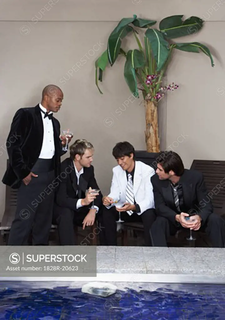 Men in Formal Wear Drinking Cocktails Poolside   