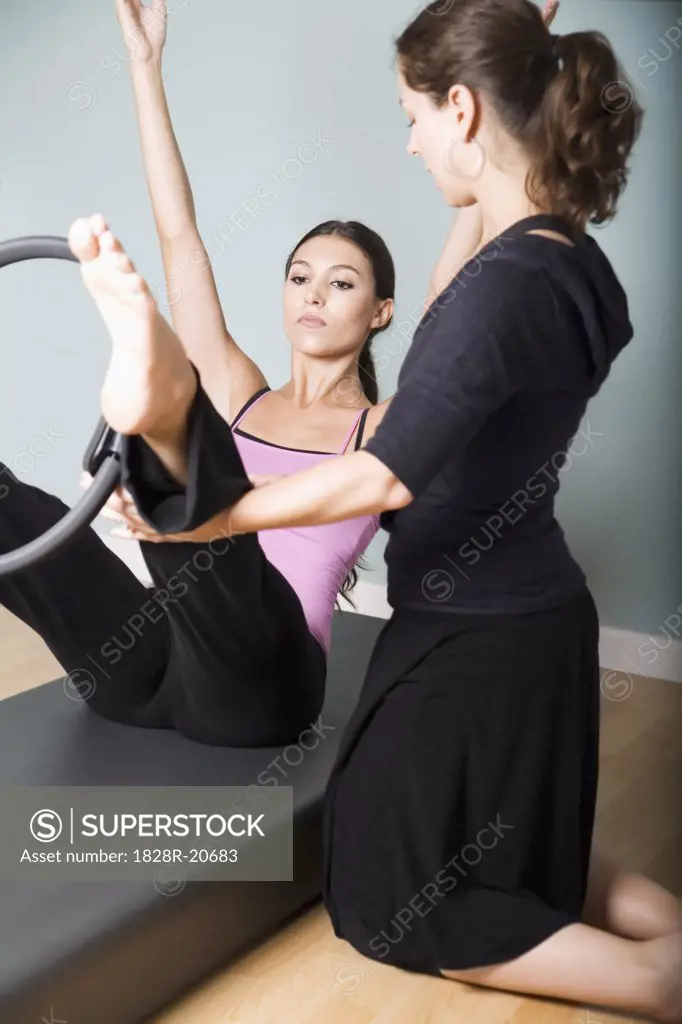 Woman Exercising with Personal Trainer   