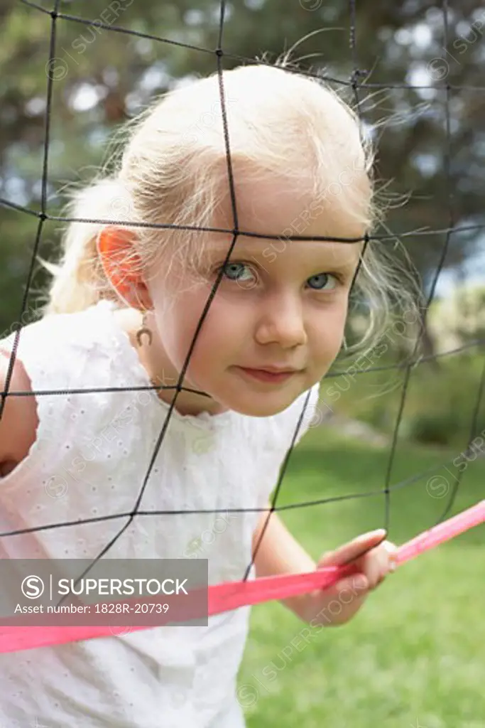Girl Looking through Badminton Net   