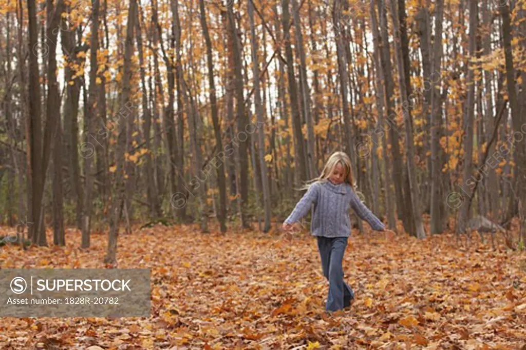 Girl Walking in Leaves   