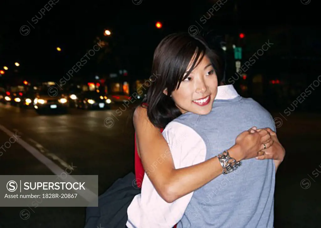 Couple Hugging in City   