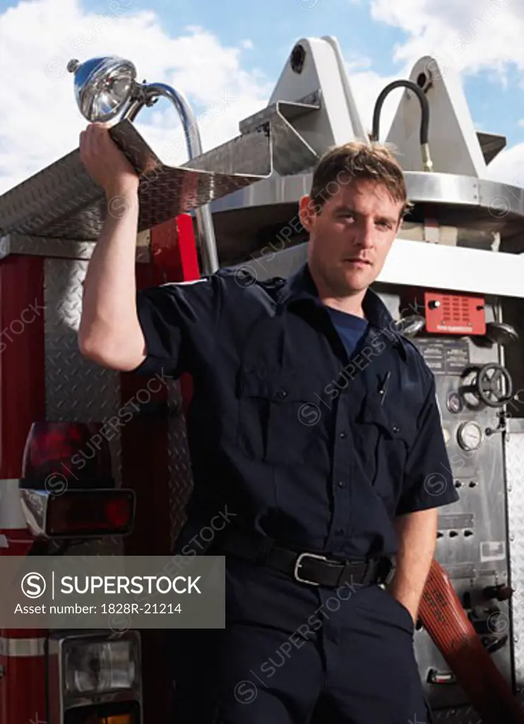 Firefighter on Back of Fire Truck   