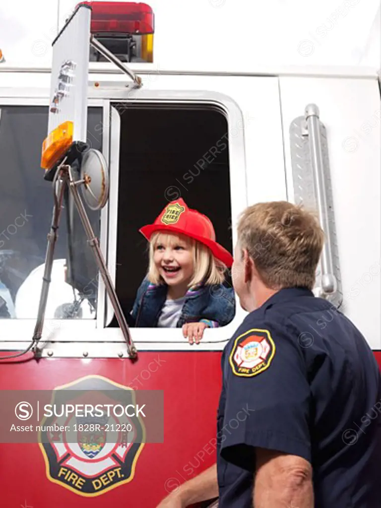 Man Looking at Girl in Fire Truck   