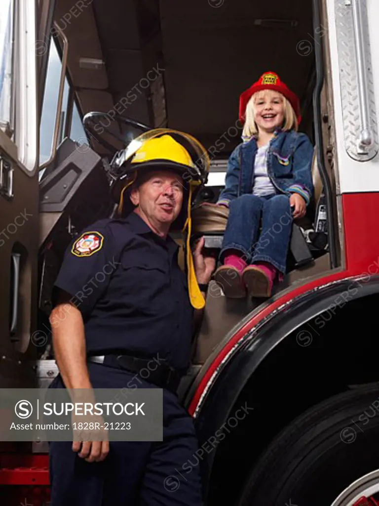 Girl and Firefighter in Fire Truck   