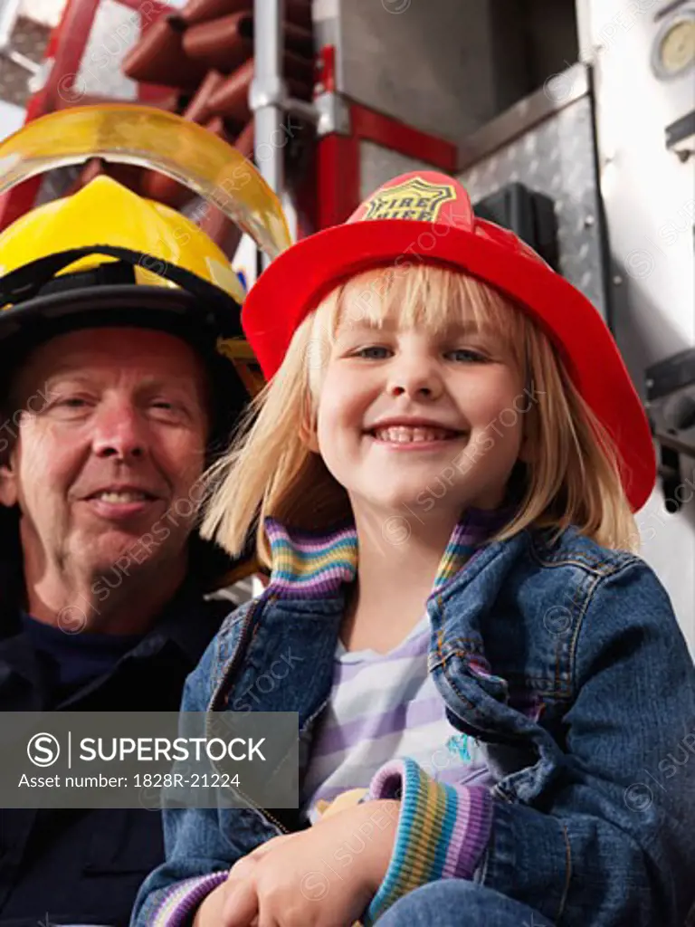 Girl and Firefighter by Fire Truck   