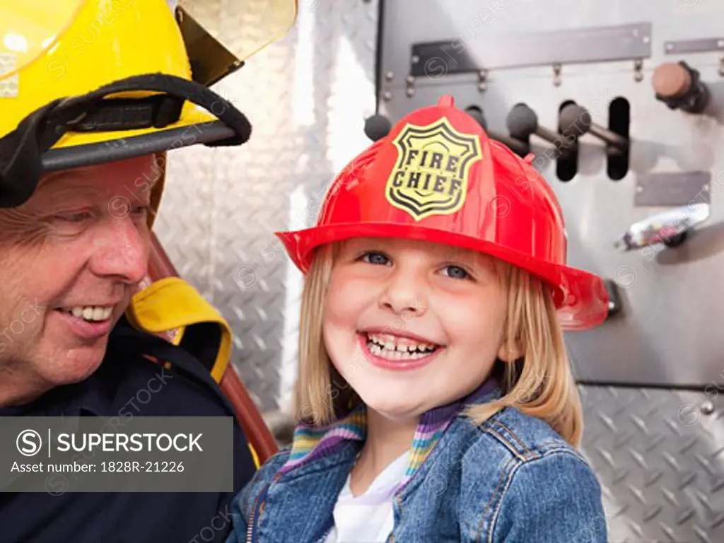 Girl and Firefighter by Fire Truck   