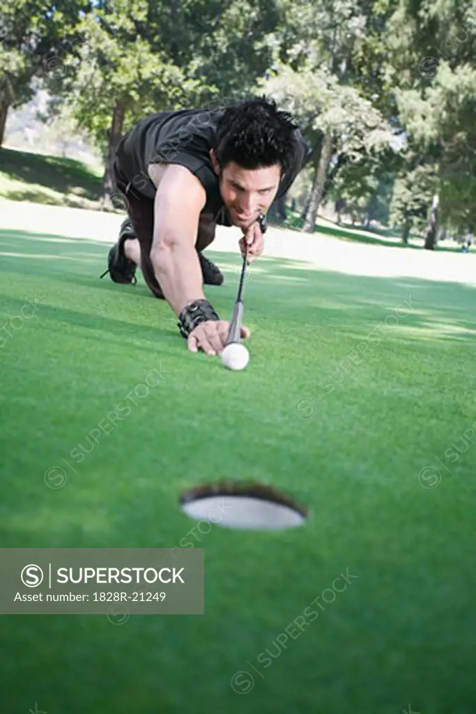Man Playing Pool on Golf Course   