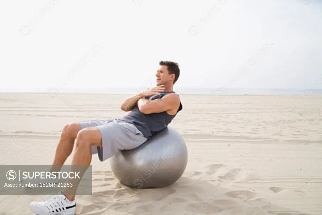 Man Doing Sit-Ups at Beach   