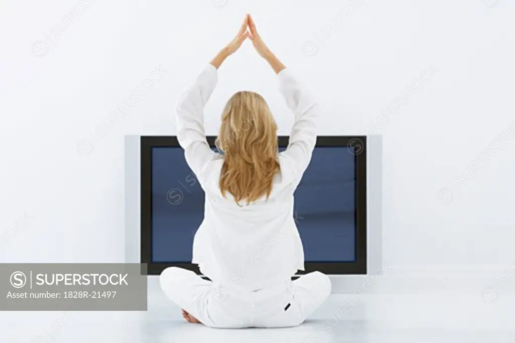 Woman Doing Yoga in Front of Television   