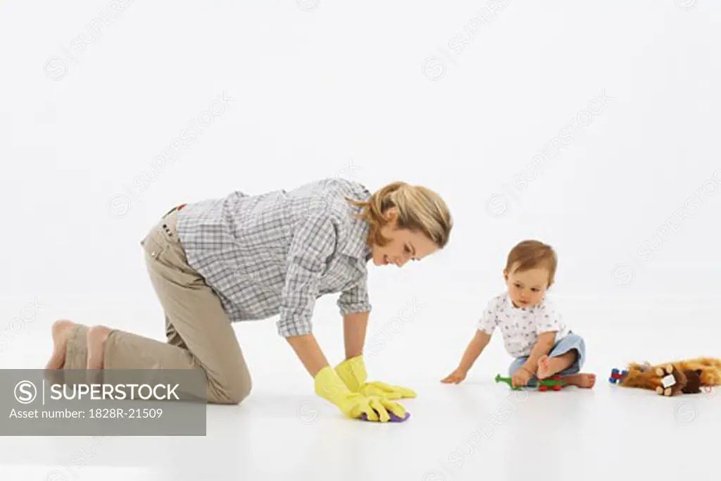 Mother Scrubbing Floor, Baby Playing   