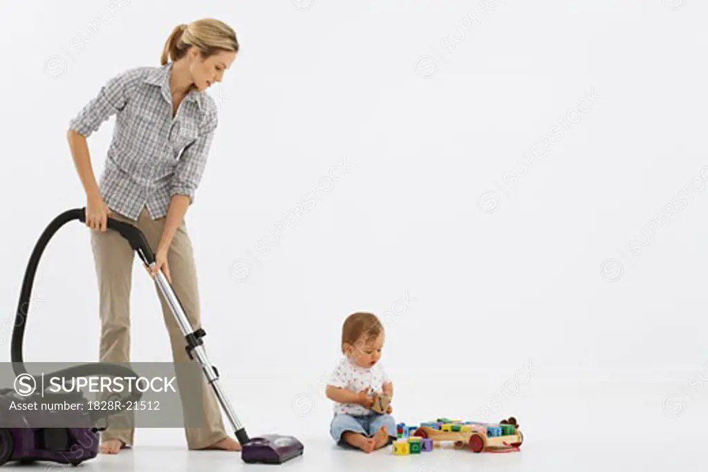Woman Vacuuming, Baby Playing with Toys   