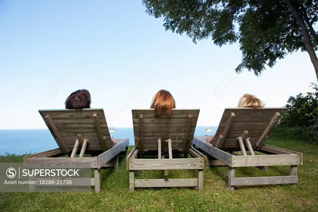 Women Sitting Outdoors   