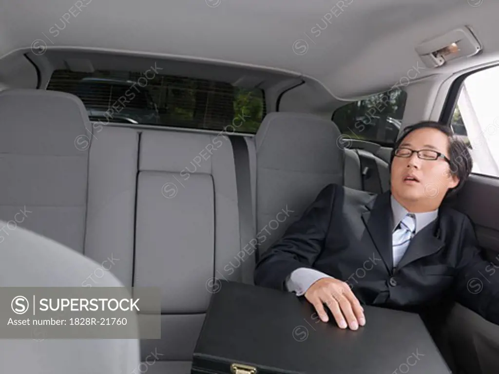Businessman Sleeping in Car   