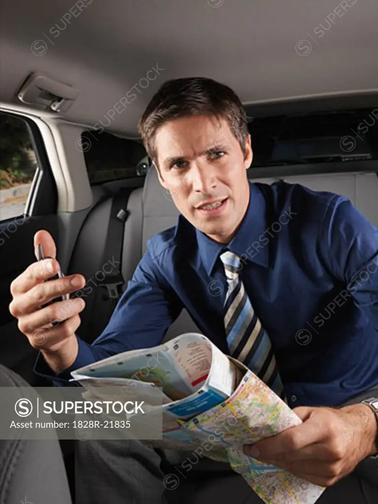 Businessman Holding Map   