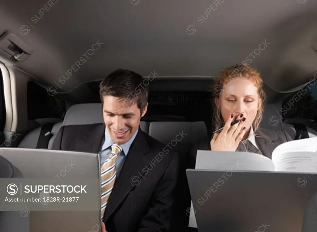 Businesspeople Working in Back of Car   