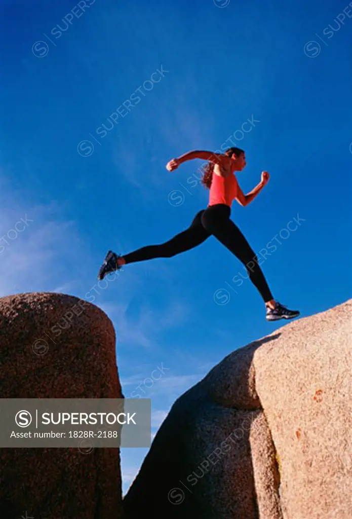 Woman Jumping Gap Joshua Tree, California, USA   