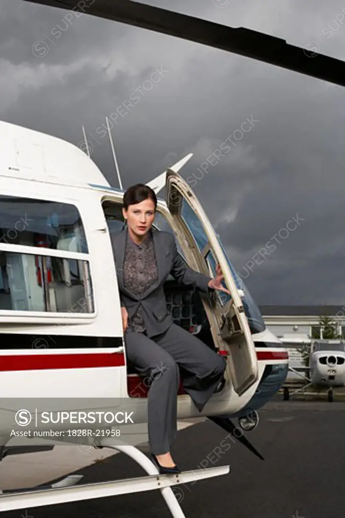 Businesswoman Getting Out of Helicopter   