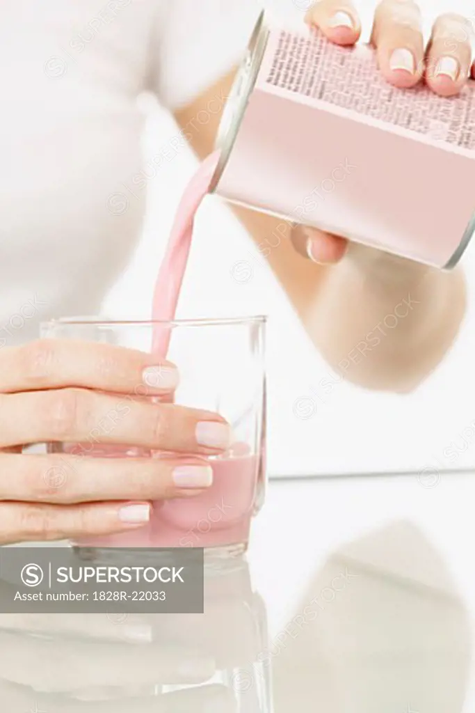 Woman Pouring Meal Replacement Beverage   