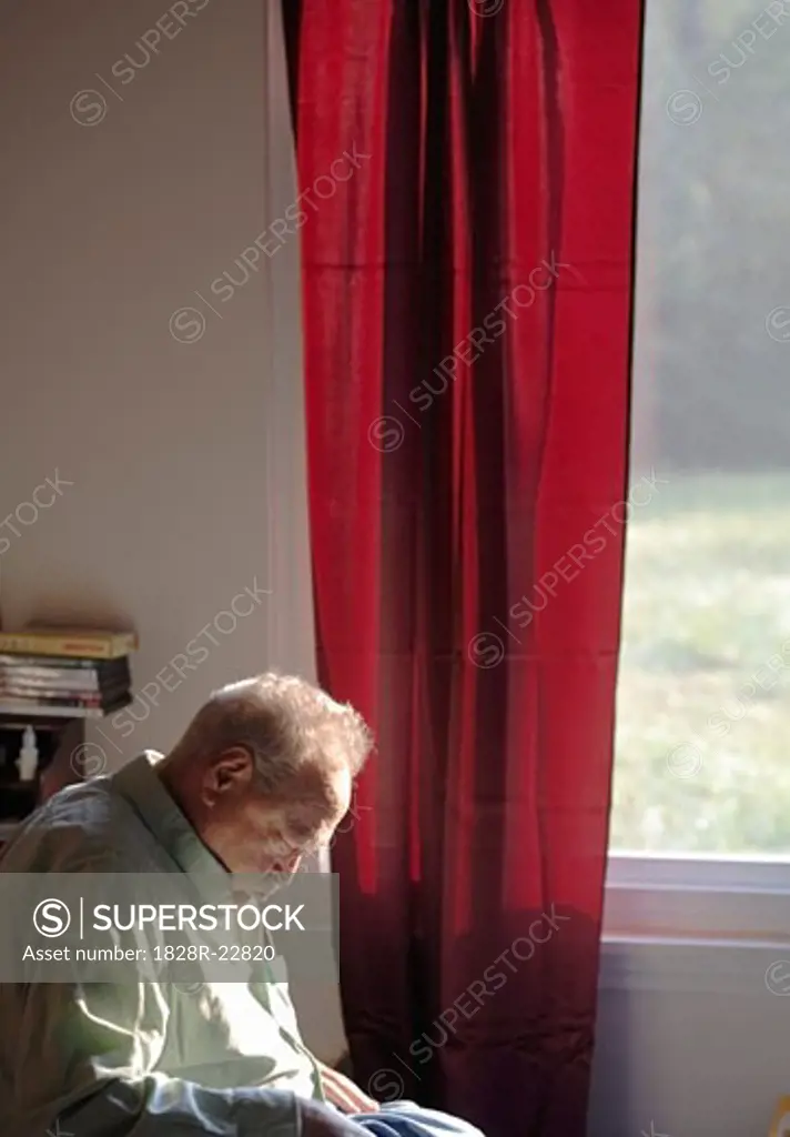 Man Sleeping in Chair by Window   