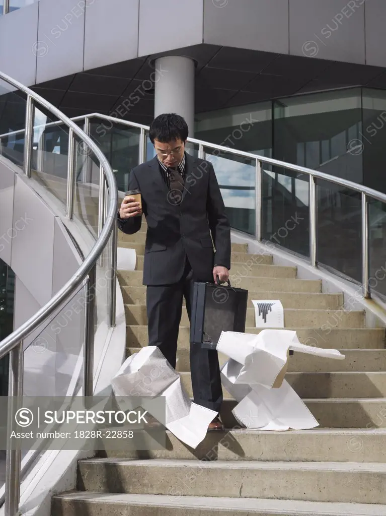 Businessman Dropping Papers on Staircase   