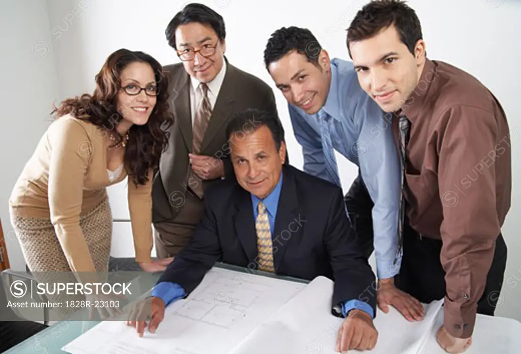 Business People Looking at Blueprints   