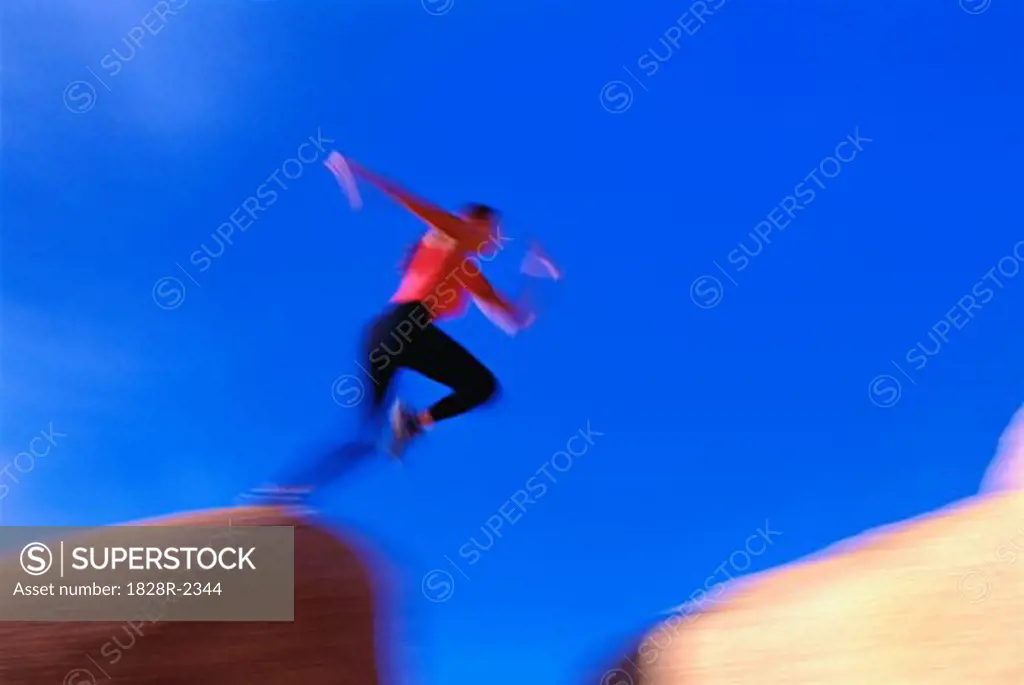 Blurred View of Woman Jumping Over Gap Joshua Tree, California, USA   