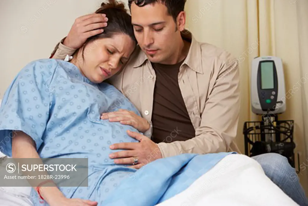 Husband Comforting Pregnant Wife   