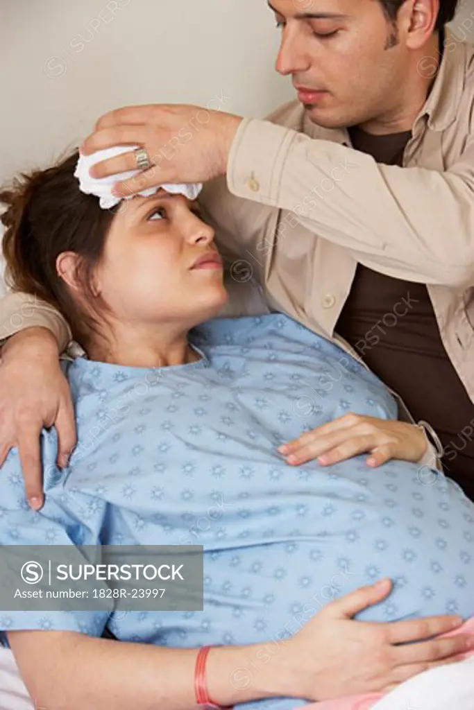 Husband Comforting Pregnant Wife   