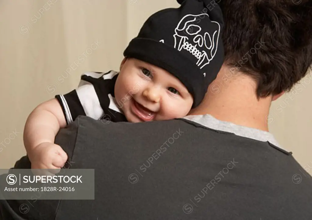 Baby Looking Over Father's Shoulder   